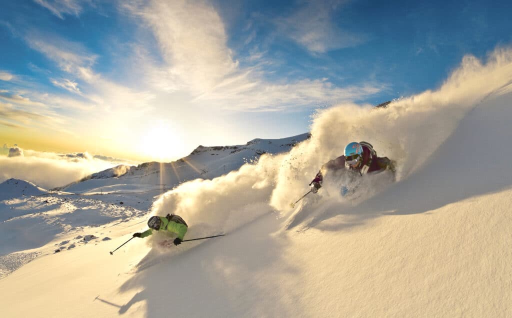 La Parva in Chile with two skiers carving through deep powder