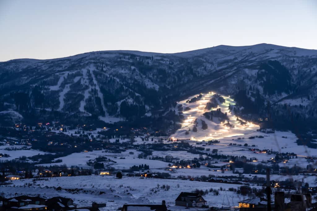 Night skiing at Nordic Valley with sunset n the back